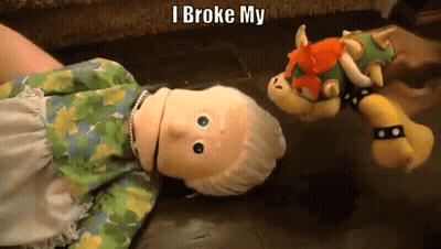 Stuffed Doll Laying On Couch Next To Stuffed Animal Saying I Broke My GIF