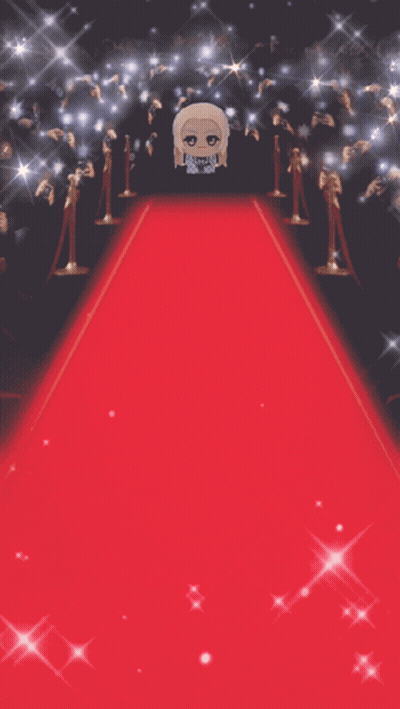 Stuffed Doll Standing On Red Carpet In Front Of Crowd GIF