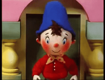 Stuffed Gnome Blue Hat Red Shirt Pink Building GIF