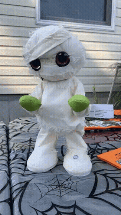 Stuffed Mummy Standing On Spider Web Table Cloth GIF