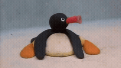 Stuffed Penguin Blowing Balloon GIF