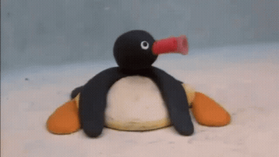 Stuffed Penguin Blowing Balloon GIF