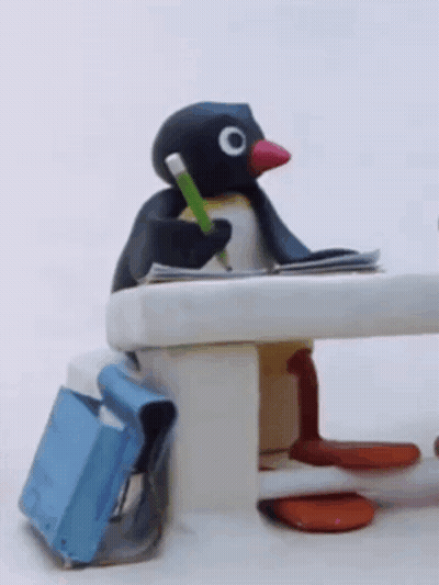 Stuffed Penguin Sitting At Table With Pencil GIF