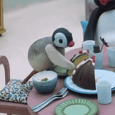 Stuffed Penguin Sitting With Cake GIF