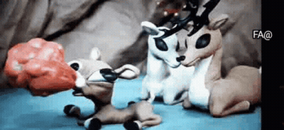 Stuffed Reindeer Sitting On Bed GIF