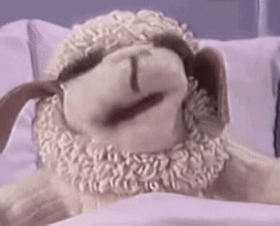 Stuffed Sheep Laying On Bed Mouth Open GIF