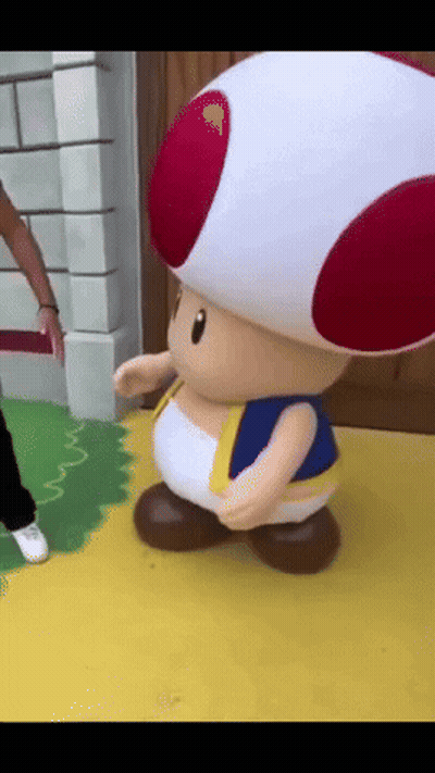 Stuffed Toad With Red And White Hat On Yellow Floor GIF