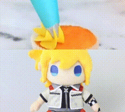Stuffed Toy With Yellow Hair And Blue Eyes Decorated With Icing GIF