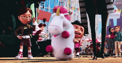 Stuffed Unicorn With Pink Horn Held By Girl In Glasses GIF