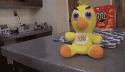Stuffed Yellow Duck Next To Ritz Chips Box GIF
