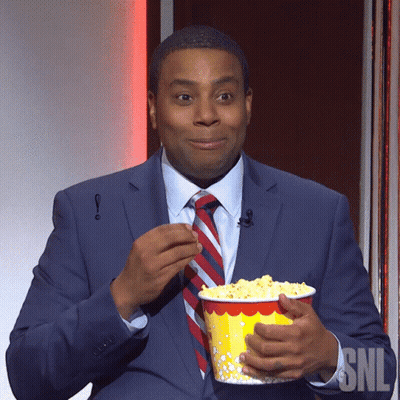 Suit-And-Tie Man Holding Popcorn At SNL Sign GIF