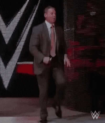 Suit And Tie Man Walking Down Stage GIF