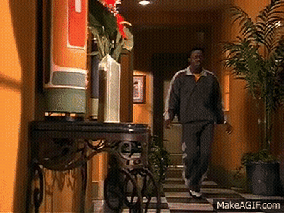 Suit And Tie Man Walks Past Blue Car GIF