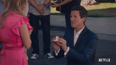 Suit Man Proposing Woman Pink Dress Netflix Logo GIF