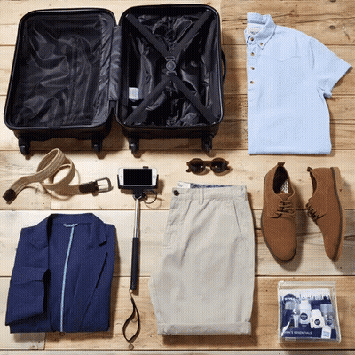 Suitcase Surrounded By Clothes And Selfie Stick GIF