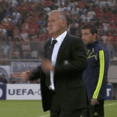 Suited Man At UEFA Sign On Soccer Field GIF