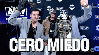 Suited Man Holding Wrestling Championship TNT Logo GIF