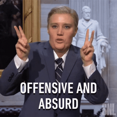 Suited Man Making Peace Sign Saying Offensive Absurd GIF
