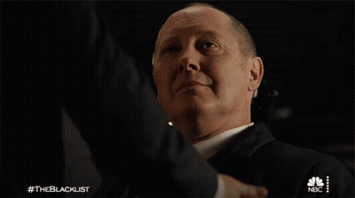 Suited Man Shaking Hands With NBC Logo GIF