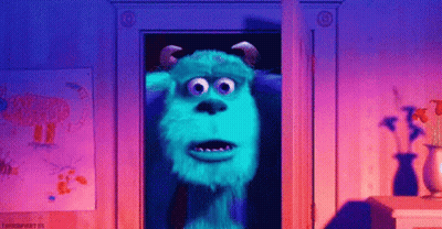 Sulley From Monsters Inc Is Standing In A Doorway In A Room . GIF