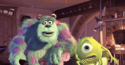 Sully And Mike From Monsters Inc Are Standing Next To Each Other In A Room GIF