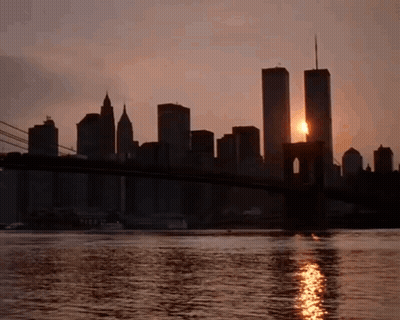 Sun Setting Behind Twin Towers And Bridge GIF