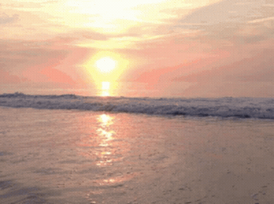 Sun Setting Over Breaking Waves GIF