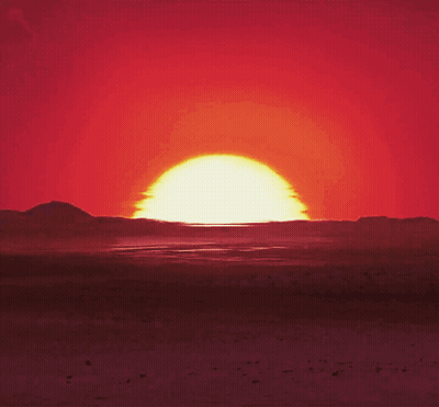 Sun Setting Over Desert Mountains GIF