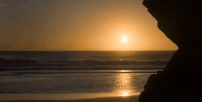 Sun Setting Over Ocean Waves GIF