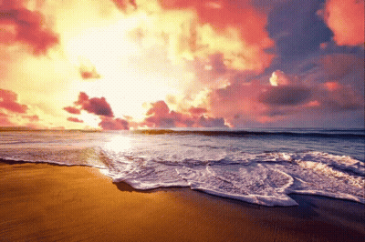 Sun Setting Over Ocean Waves Crashing On Sand GIF