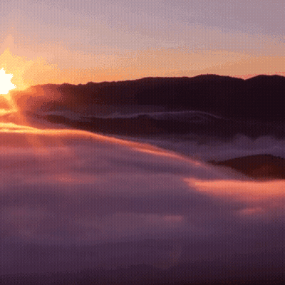 Sun Shining Through Clouds In Mountains GIF
