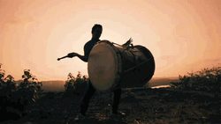 Sunset Man Playing Big Drum GIF