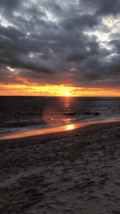 Sunset Over Ocean With Few Clouds GIF