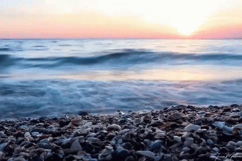 Sunset Over Rocky Beach Water