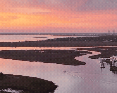 Sunset Over Water With Bridge GIF
