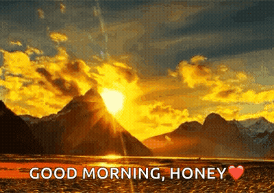 Sunset Through Clouds Over Lake And Mountains GIF