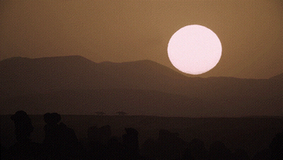 Sunset With Mountains And Large Pink Sun GIF