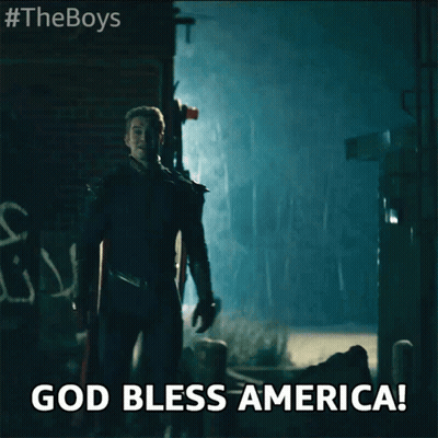 Superhero In Dark Alley Saying God Bless America GIF