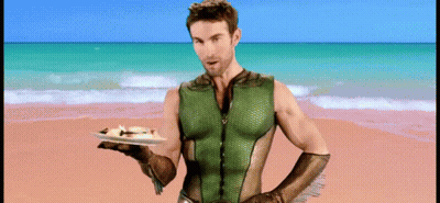 Superhero Man Holding Food On Beach GIF