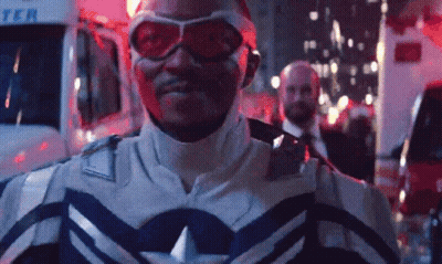 Superhero Man In Front Of Ambulance At Night GIF