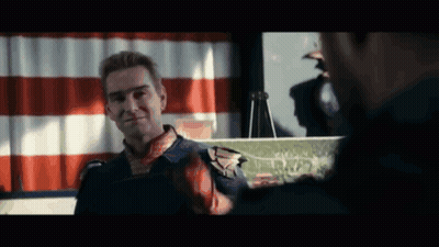 Superhero Talking To Man In Front Of Flag GIF