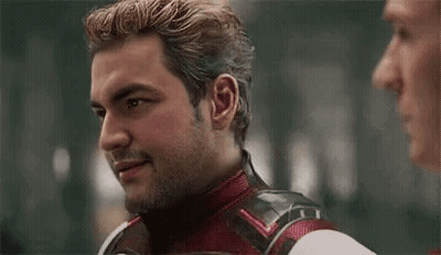 Superhero Talking To Man Making Funny Face GIF