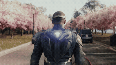 Superhero Walking Down Cherry Blossom Street GIF