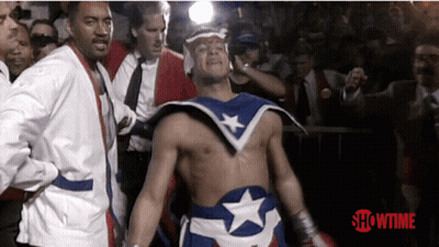 Superhero Walking In Front Of Showtime Sign GIF