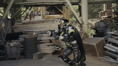 Superhero Walking Through Wood Pile GIF