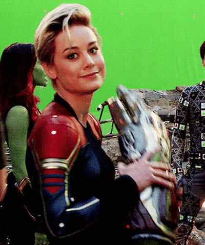Superhero Woman Holding Helmet Smiling GIF