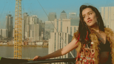 Superman And Batman Standing In Front Of Cityscape GIF