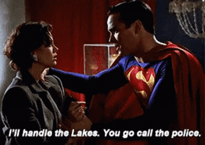 Superman Holding Woman's Hand And Talking GIF