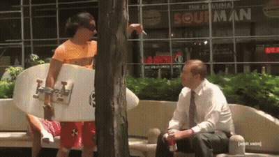 Surfboard Man Talking To Man At Original Sour Man GIF