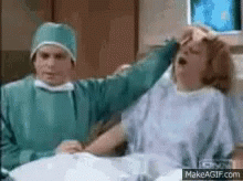 Surgeon Holding Woman's Head GIF